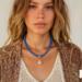 Bead & Braid Collective minimalist model shot of handcrafted Kumihimo necklace with blue beads and rose quartz drop